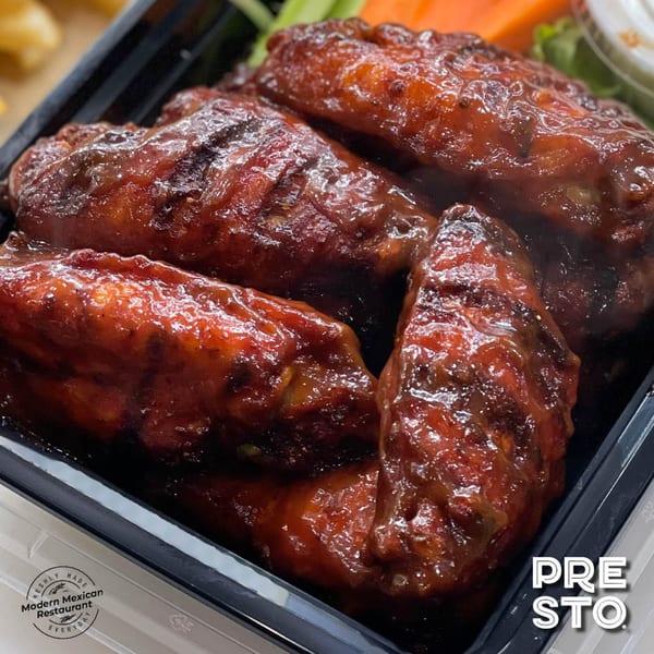 PRESTO FRESH CAFE CORP's Mexican-style chicken wings, glazed in a rich, dark red sauce, with vegetables.
